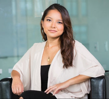 Woman sitting in a chair with a blurred office background