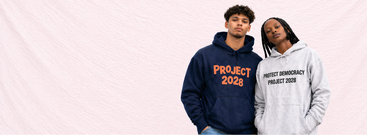 Two people wearing hoodies with 'Project Democracy 2028' text on a light gray background1621243260e1af0c20-1